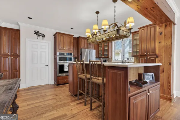 a bed sitting in a spacious bedroom next to a window