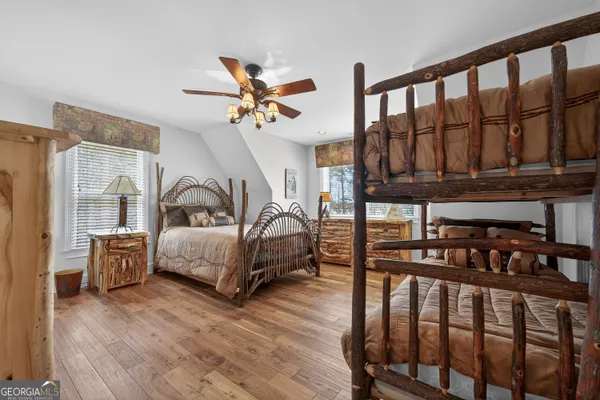 a bedroom with a large bed and a chandelier