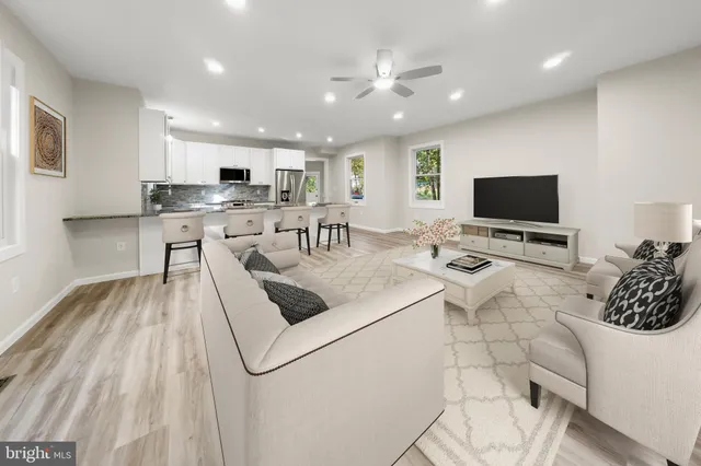 a kitchen with stainless steel appliances granite countertop a sink refrigerator and microwave