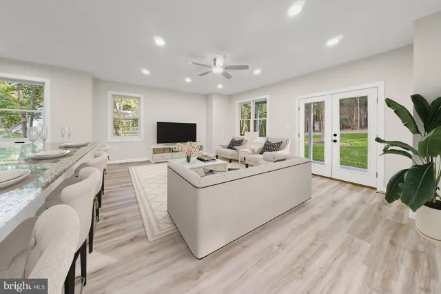 a large kitchen with granite countertop a sink stainless steel appliances and cabinets
