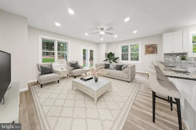 a large kitchen with stainless steel appliances granite countertop a refrigerator and a sink