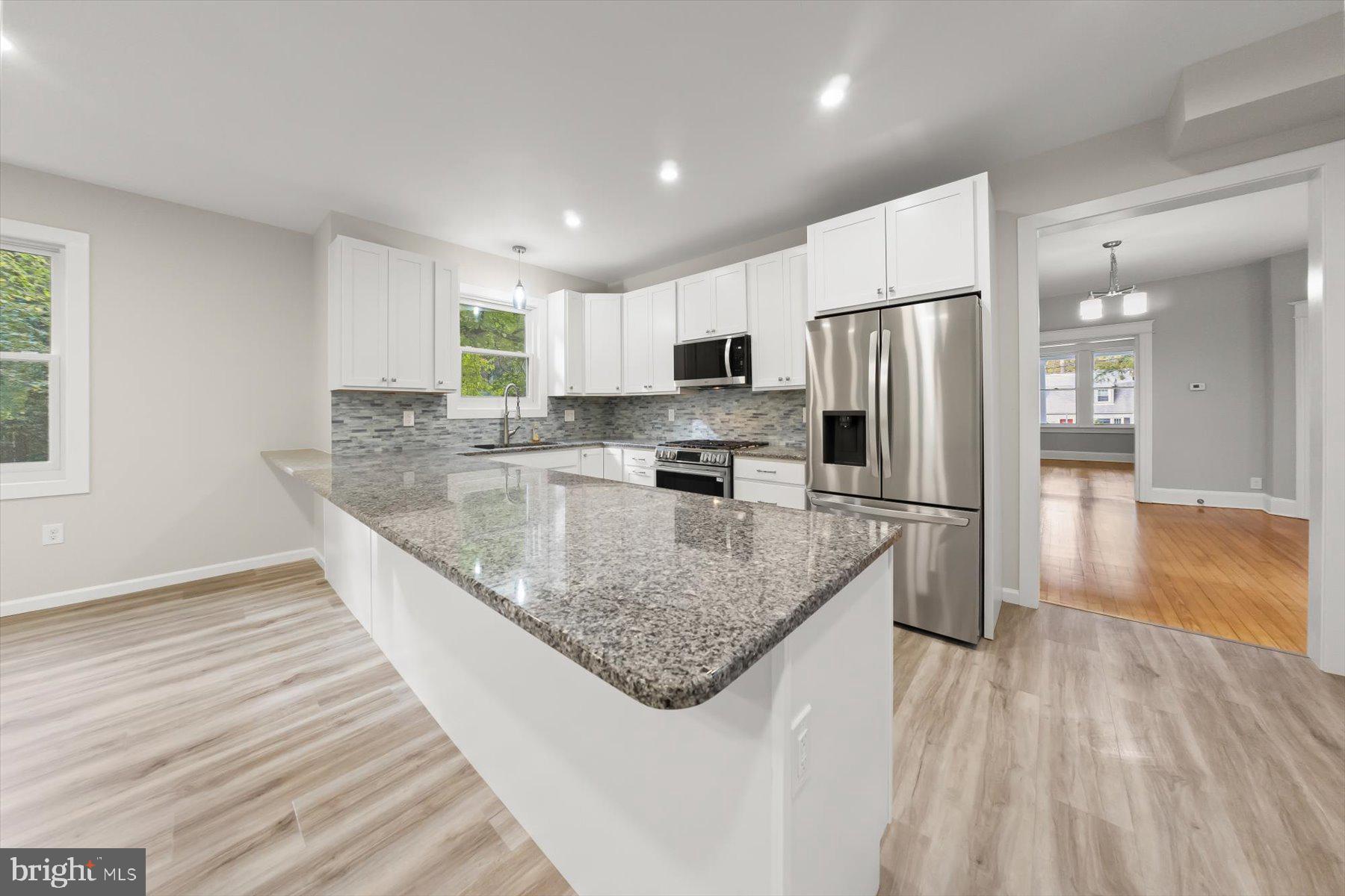 10220 Capitol View Avenue Silver Spring, MD 20910 - Photo 27 of 66 a kitchen with stainless steel appliances granite countertop a sink refrigerator and microwave