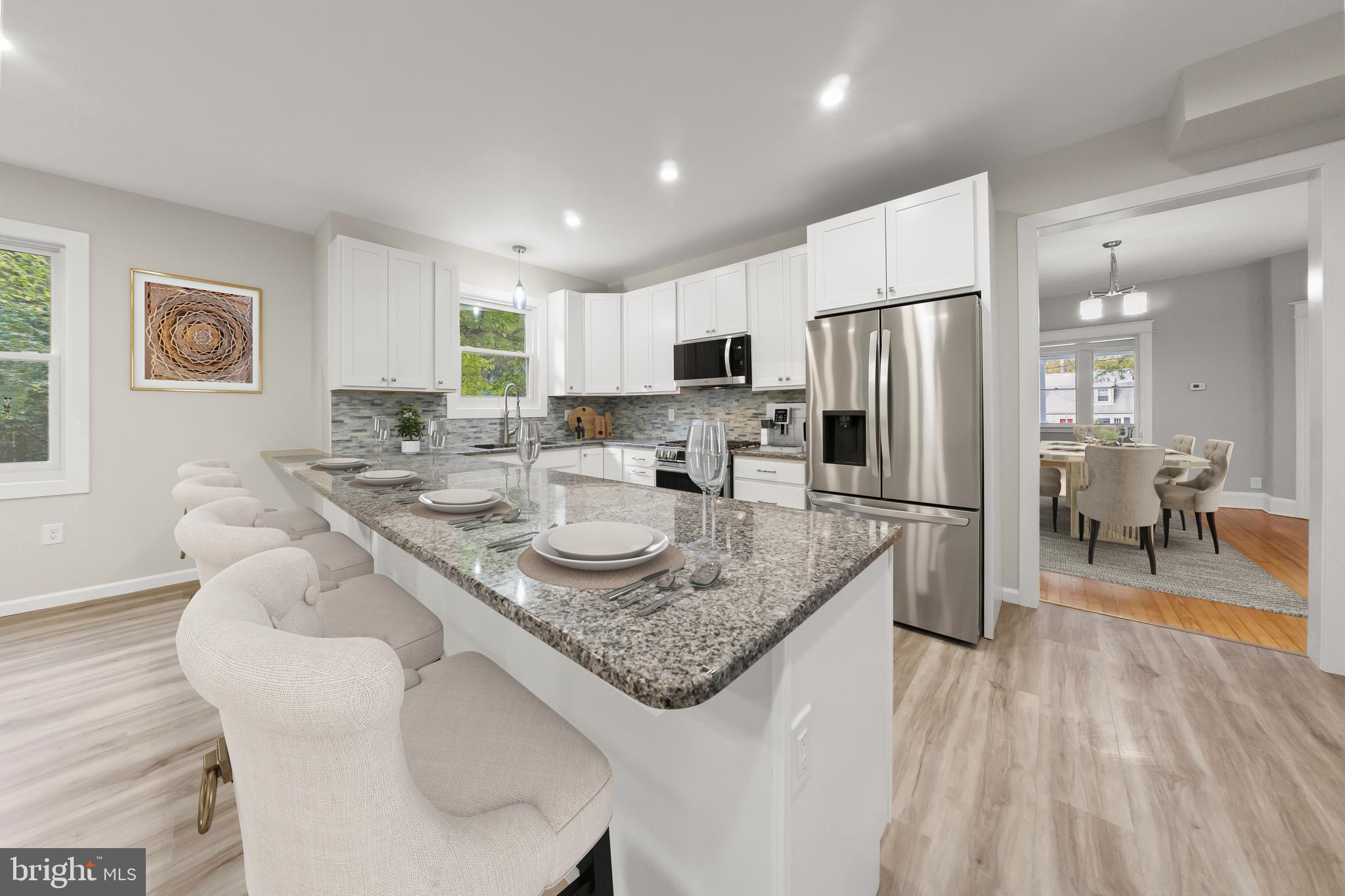 10220 Capitol View Avenue Silver Spring, MD 20910 - Photo 28 of 66 a kitchen with stainless steel appliances granite countertop a sink refrigerator and chairs