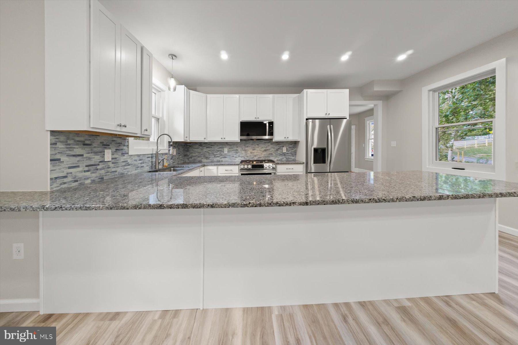 10220 Capitol View Avenue Silver Spring, MD 20910 - Photo 29 of 66 a large kitchen with granite countertop a sink stainless steel appliances and cabinets