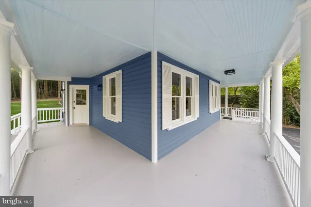 a dining room with furniture and a potted plant