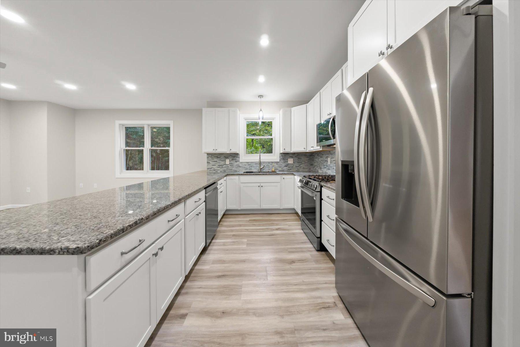 10220 Capitol View Avenue Silver Spring, MD 20910 - Photo 31 of 66 a large kitchen with stainless steel appliances granite countertop a refrigerator and a sink