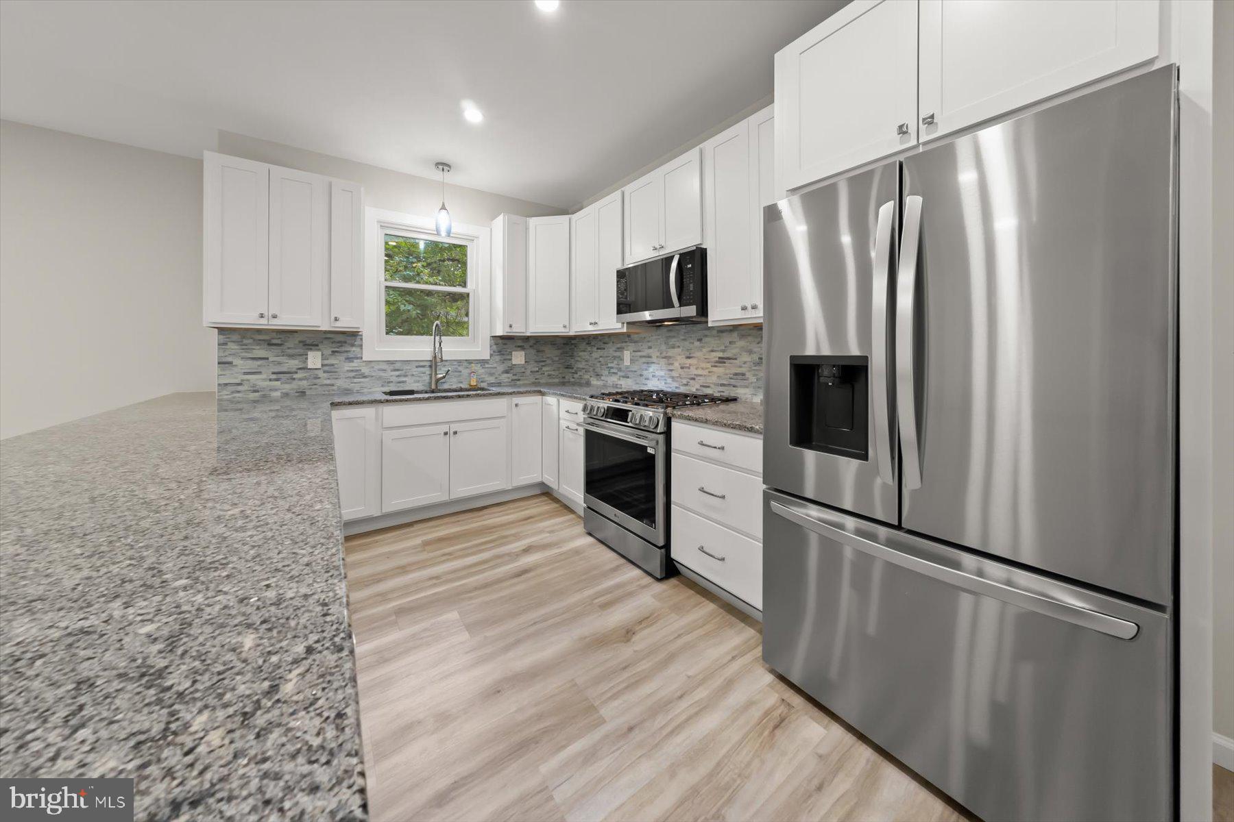 10220 Capitol View Avenue Silver Spring, MD 20910 - Photo 33 of 66 a kitchen with granite countertop stainless steel appliances a refrigerator sink and microwave