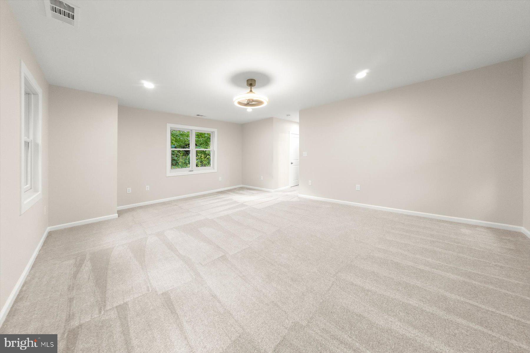 10220 Capitol View Avenue Silver Spring, MD 20910 - Photo 41 of 66 an empty room with windows and ceiling fan