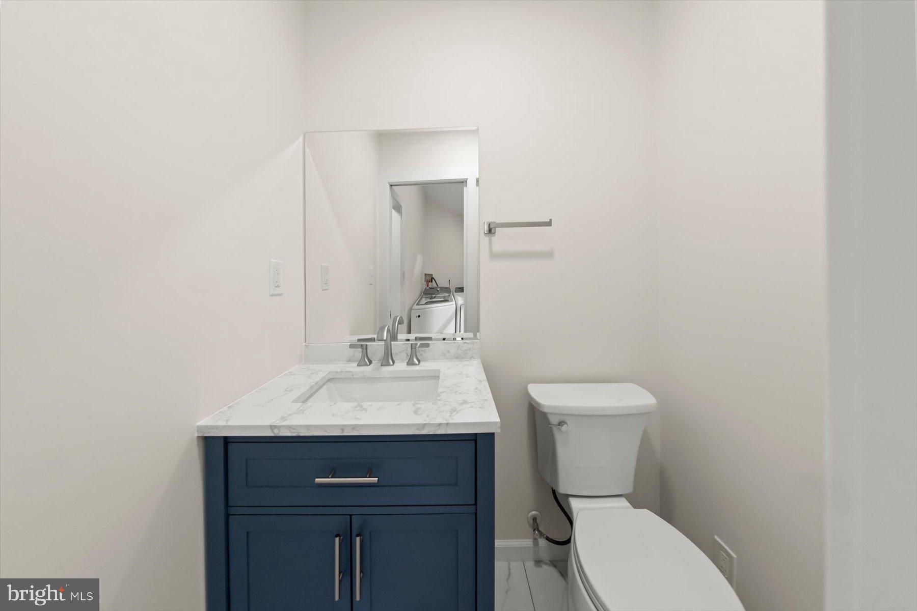 10220 Capitol View Avenue Silver Spring, MD 20910 - Photo 46 of 66 a bathroom with a toilet a sink and mirror