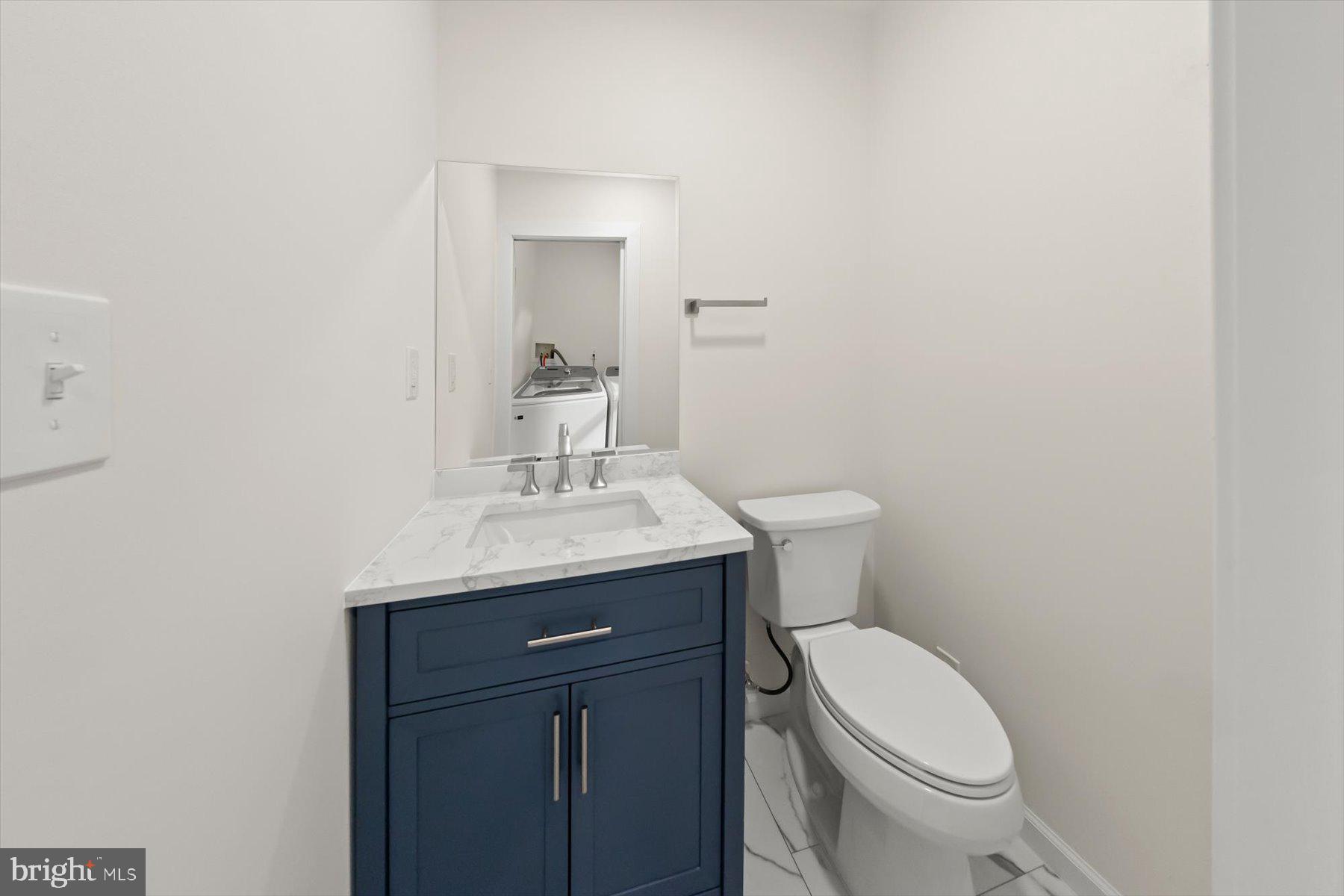 10220 Capitol View Avenue Silver Spring, MD 20910 - Photo 47 of 66 a bathroom with a sink a toilet and mirror