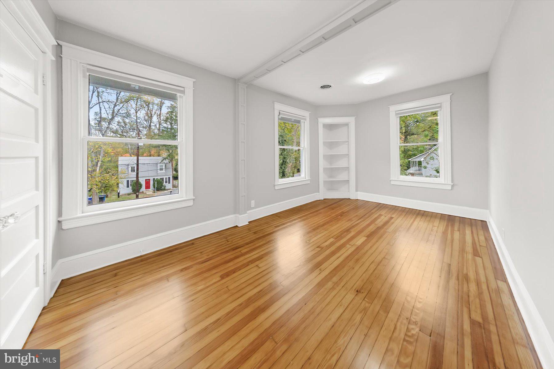 10220 Capitol View Avenue Silver Spring, MD 20910 - Photo 49 of 66 a view of an empty room with wooden floor and a window