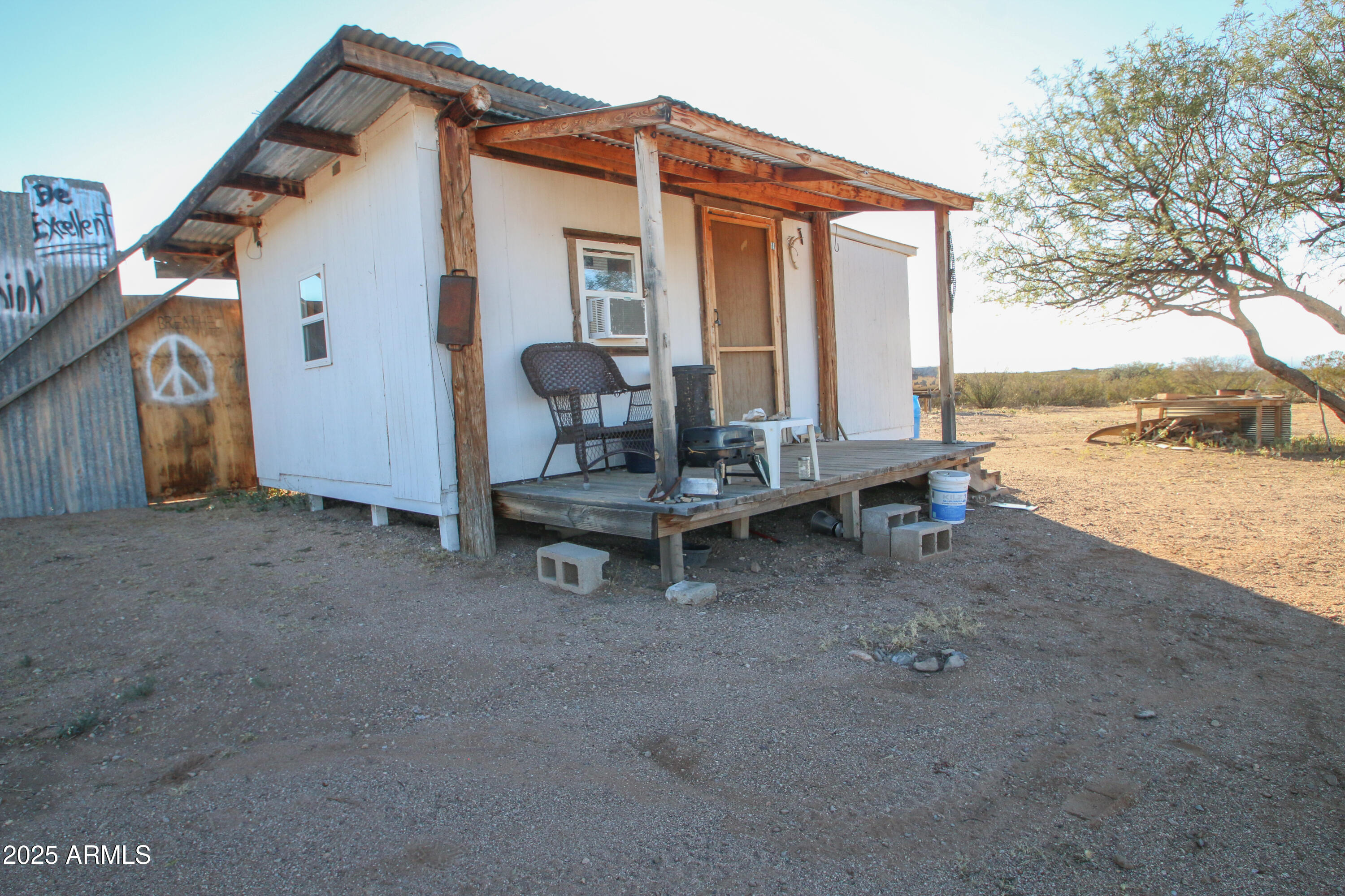 87 East Desert Meadow Road Tombstone, AZ 85638 - Photo 1 of 17 a view of a house with backyard and sitting area