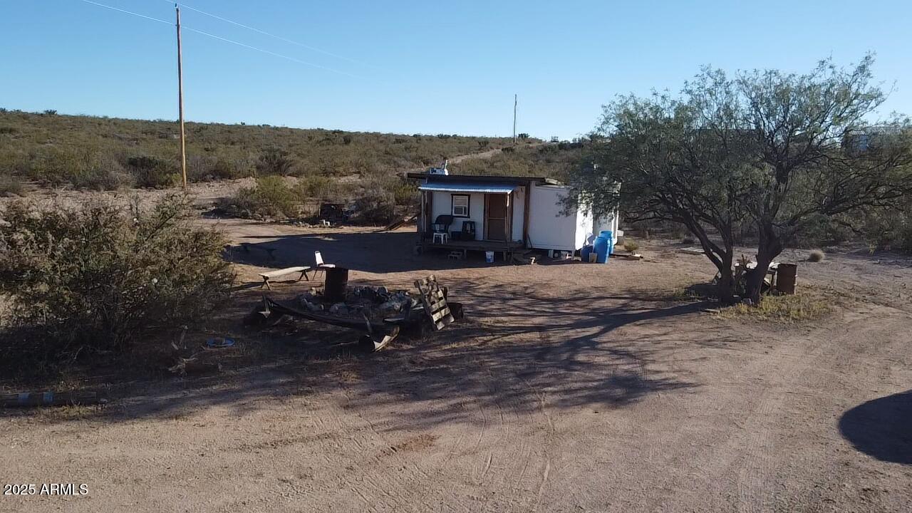 87 East Desert Meadow Road Tombstone, AZ 85638 - Photo 11 of 17 a view of a house with a yard