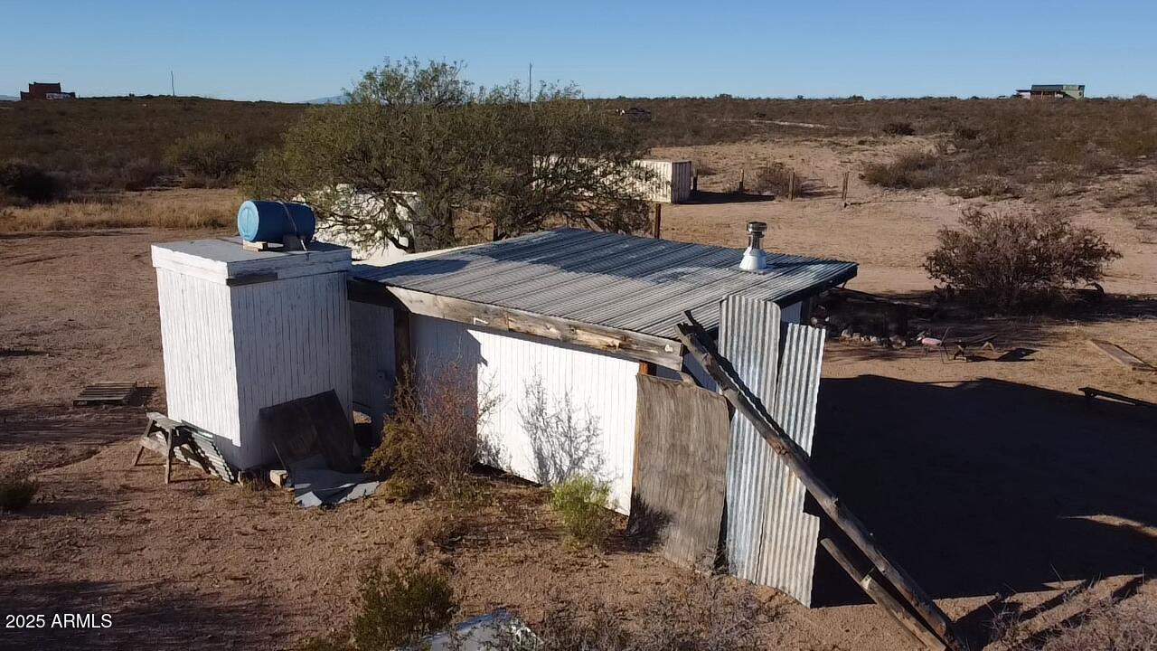 87 East Desert Meadow Road Tombstone, AZ 85638 - Photo 5 of 17 a view of a terrace with a table and chairs