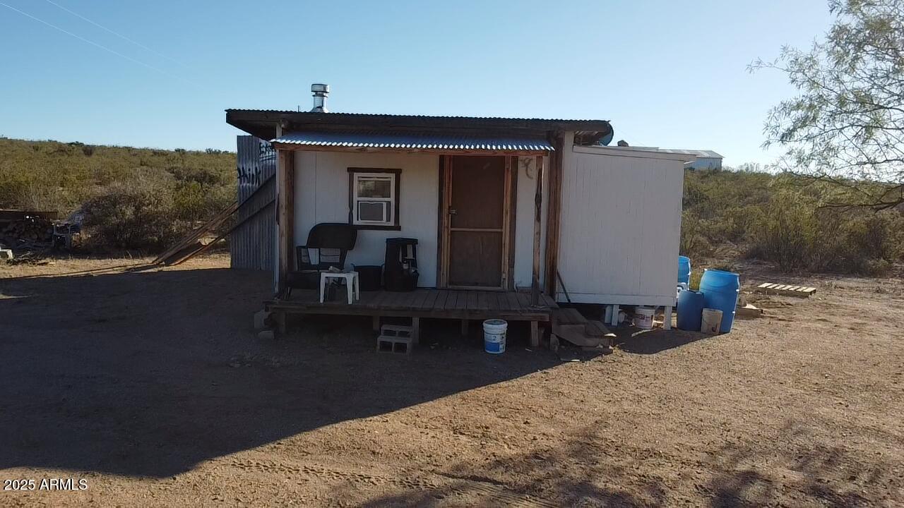 87 East Desert Meadow Road Tombstone, AZ 85638 - Photo 10 of 17 a view of house with outdoor space and sitting area
