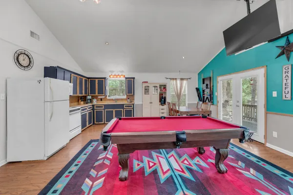 a dining room with furniture and kitchen view
