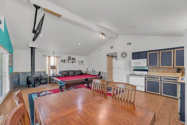 a large kitchen with stainless steel appliances kitchen island granite countertop a stove and a refrigerator