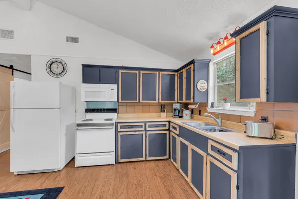 a kitchen with a sink stove and refrigerator