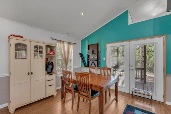 a dining room with furniture and wooden floor