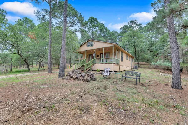a view of a house with a yard and sitting area