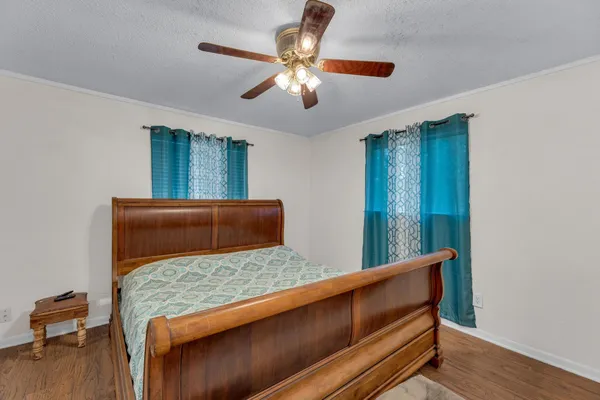 a living room with furniture and a ceiling fan