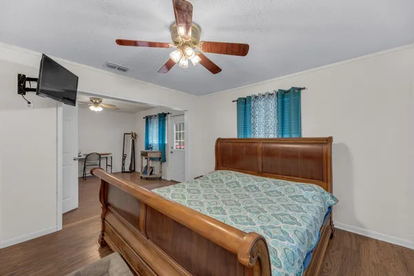 a bedroom with a large bed and a chandelier
