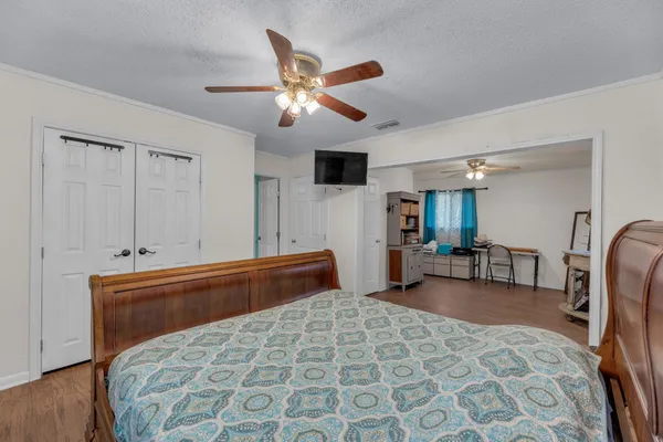 a bedroom with furniture and a chandelier