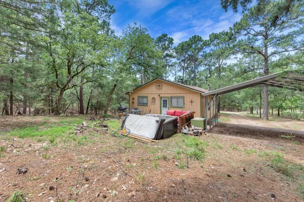 a wooden bench sitting in the middle of a yard