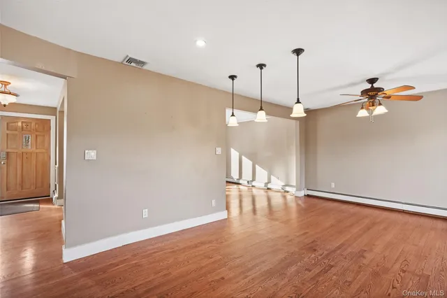 a view of a room with wooden floor