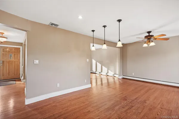 a view of a room with wooden floor