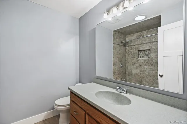 a bathroom with a sink toilet and shower