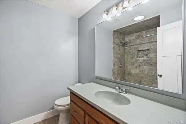 a bathroom with a sink toilet and shower
