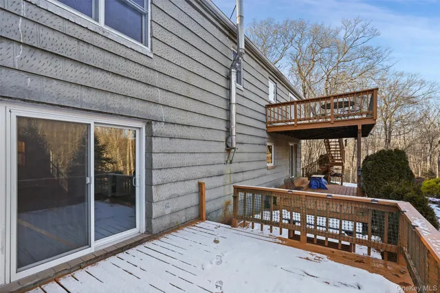 a view of a brick house with large window and outdoor space
