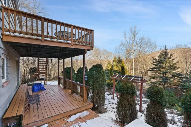 a view of a balcony with chairs and wooden floor