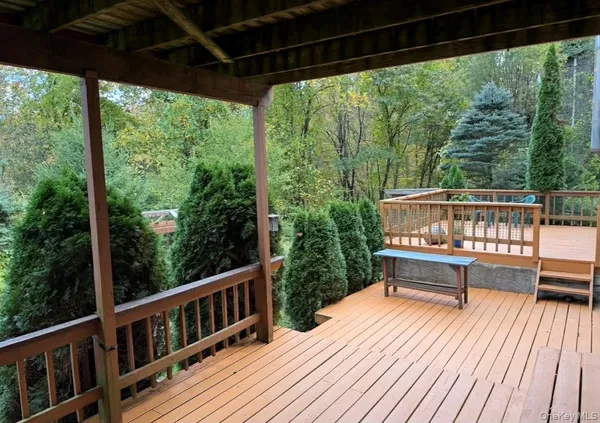 a view of roof deck with chairs and wooden floor