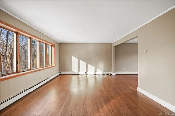 wooden floor in an empty room with a window