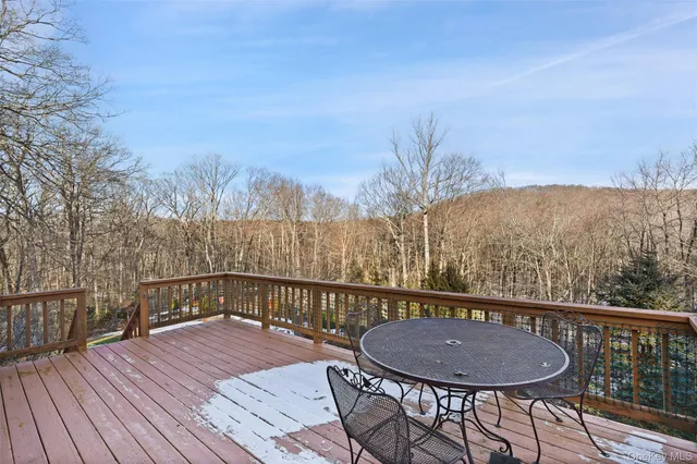 a view of a roof deck with chair and wooden floor