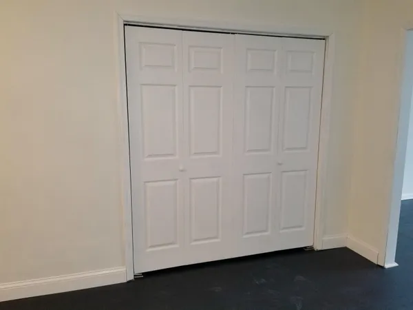 an empty room with a wooden door