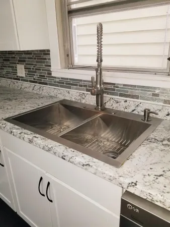 a view closed with granite countertop a sink and a stove