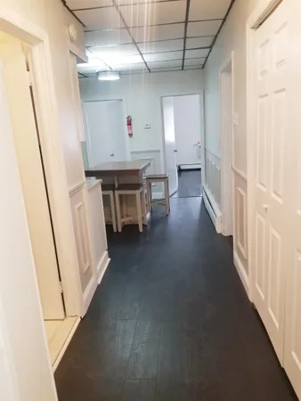 a view of hallway with furniture and a window