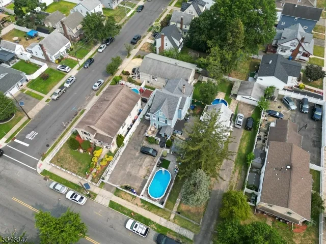 an aerial view of residential houses with outdoor space and swimming pool