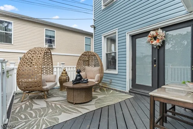 a view of a deck with table and chairs and wooden floor