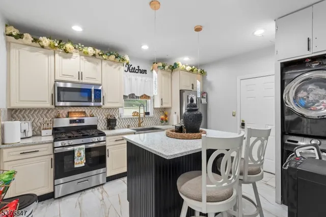 a kitchen with a stove a sink and a refrigerator