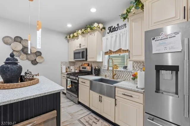 a kitchen with a sink cabinets and appliances