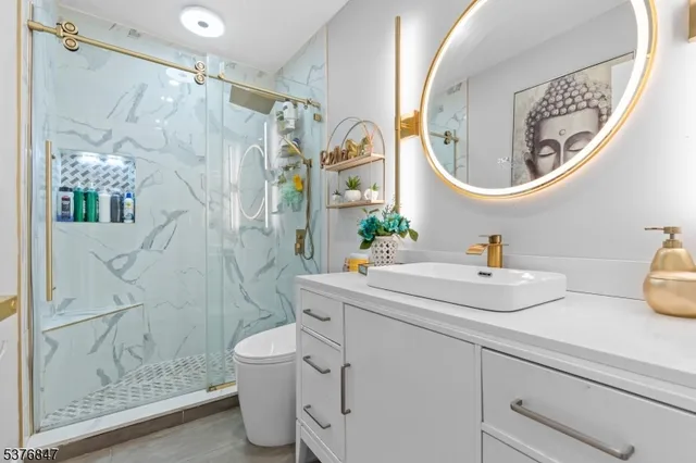 a bathroom with a sink a toilet and a mirror