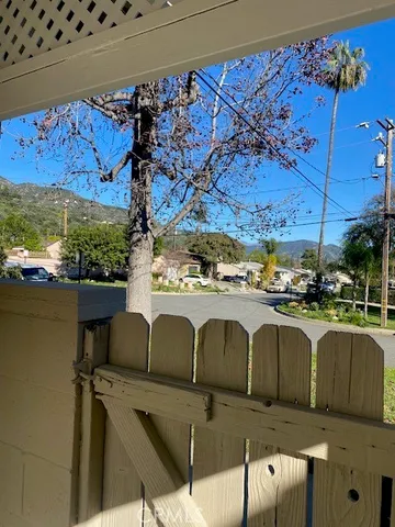 a view of a dining room with furniture and floor to ceiling window