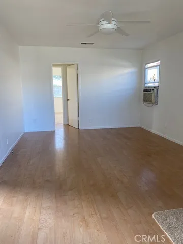 an empty room with windows and closet