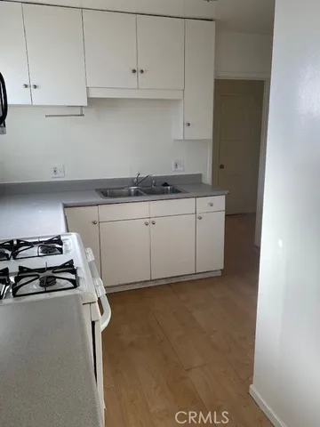 a kitchen with white cabinets and a stove