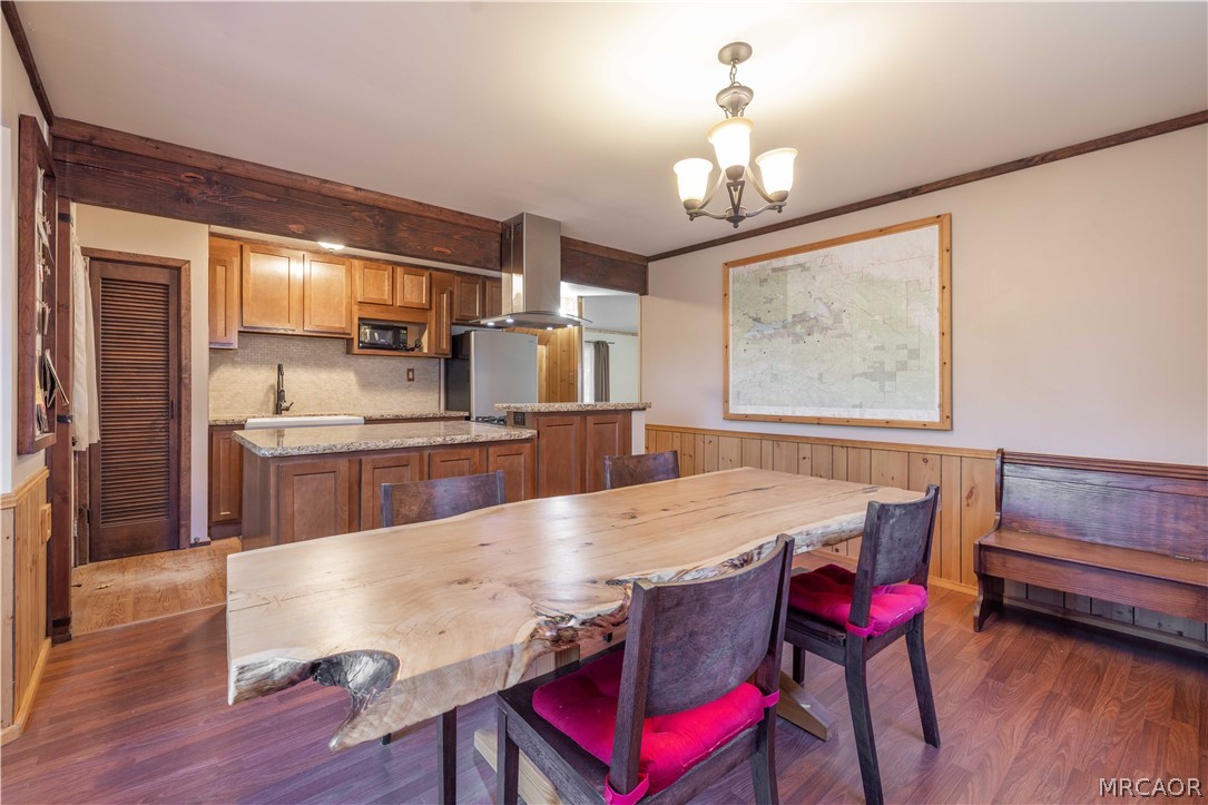 773 Sunset Lane Sugarloaf, CA 92386 - Photo 10 of 33 a living room with kitchen island granite countertop furniture wooden floor and a chandelier