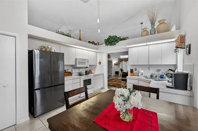 a kitchen with stainless steel appliances a sink stove and cabinets
